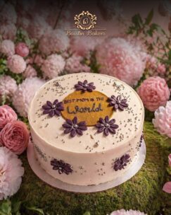 Best Mom floral celebration cake with purple flower decorations by Baistin Bakers By Cake House