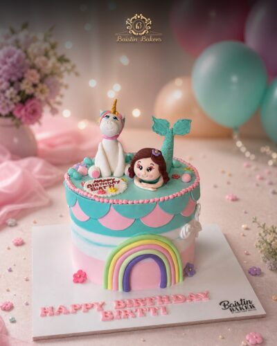 Mermaid unicorn theme birthday cake with pastel rainbow decorations by Baistin Bakers By Cake House