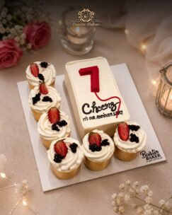 Anniversary number cake with cupcakes and strawberry toppings by Baistin Bakers By Cake House