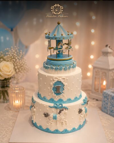 Luxury carousel first birthday cake with pastel blue fondant decorations by Baistin Bakers By Cake House