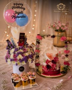 Luxury birthday hamper combo with floral cake, cupcakes, flowers, chocolates, and balloon arrangement by Baistin Bakers By Cake House