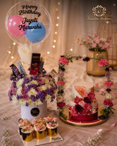 Luxury birthday hamper combo with floral cake, cupcakes, flowers, chocolates, and balloon arrangement by Baistin Bakers By Cake House
