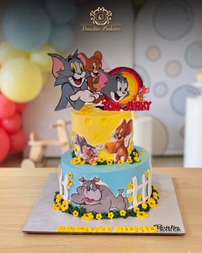 Tom and Jerry cartoon themed birthday cake with colorful character toppers by Baistin Bakers By Cake House