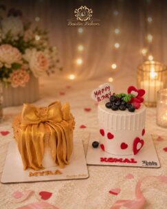 Elegant mini designer birthday cakes with gold bow decor and heart theme by Baistin Bakers By Cake House