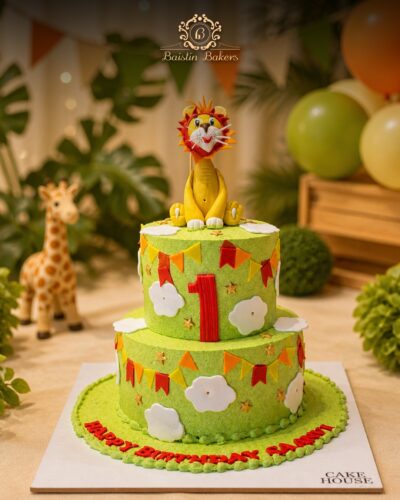 Jungle safari lion theme birthday cake with colorful animal decorations by Baistin Bakers By Cake House