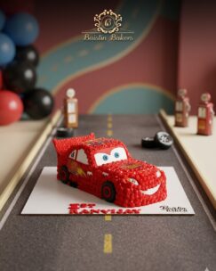 Lightning McQueen car shaped birthday cake with racing theme decoration by Baistin Bakers By Cake House