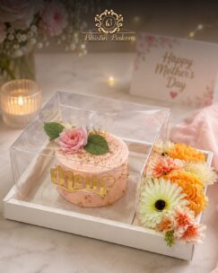 Mother’s Day floral cake hamper with pink cake and fresh flowers in premium gift packaging