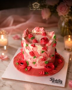 Pink floral buttercream cake with handcrafted roses and artistic texture