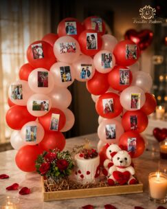 Romantic anniversary setup with balloons, photos, cake, flowers, and teddy bears