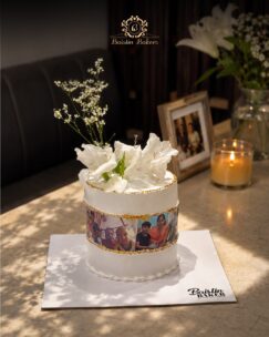 Elegant white floral cake with personalized edible photo prints