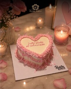 Pink vintage heart-shaped cake with ribbon piping decoration