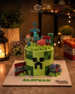 Minecraft themed birthday cake with creeper face and gaming toppers