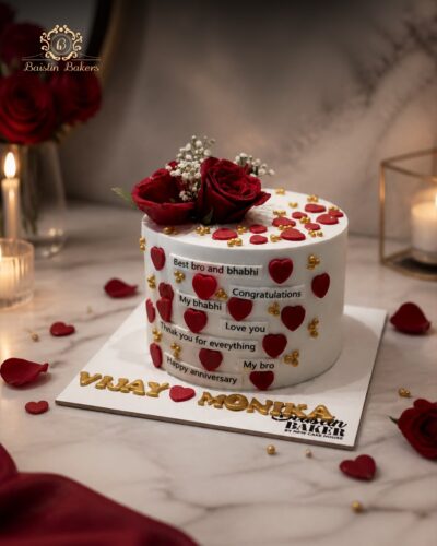 White anniversary cake decorated with red hearts