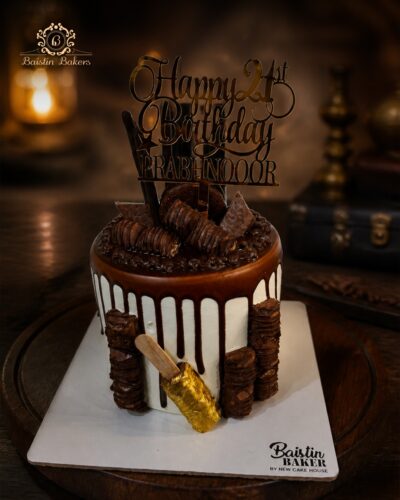 Premium chocolate drip birthday cake decorated with chocolate bars, wafer rolls, chocolate frosting, and luxury birthday topper.