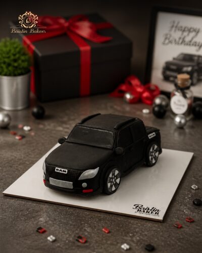Luxury black SUV-shaped designer cake for automobile and car enthusiasts.