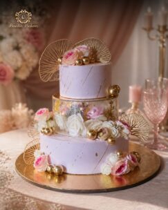 Luxury blush pink floral designer cake with roses and gold accents by Baistin Bakers Jalandhar